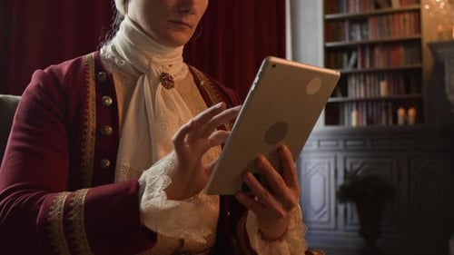 Actor in Lord Costume Using Tablet on Historical Drama Set in Palace