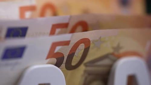 Close up of euro banknotes while counting. Financial money currency counting machine.