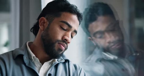 Sad, thinking and business man by glass with stress for failure, job loss and bankruptcy