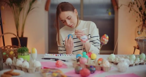 Portrait of Woman Painting Easter Eggs for Easter Holidays