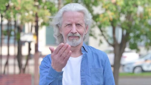Portrait of Old Man inviting People Outdoor