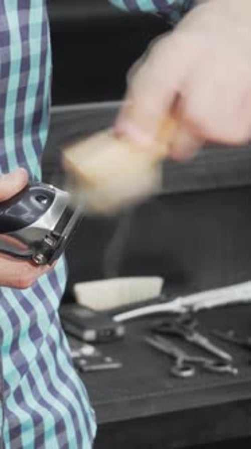 Meticulous Barber Cleaning His Electric Clipper with Precision After a Busy Day