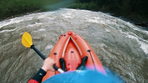 A Man on Rafting Floats on a Mountain River Through the Rapids in Spring