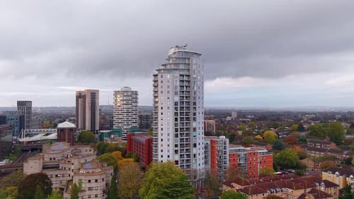 Panoramic aerial view rising above Croydon high rise city apartment towers under overcast skyline