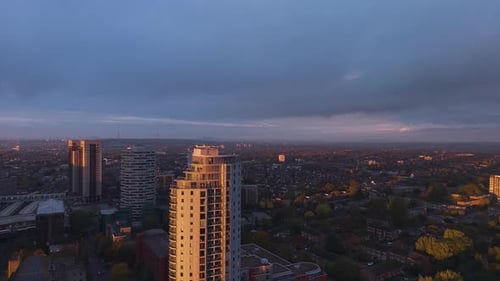 Overcast aerial view overlooking Croydon downtown high rise property and sunlit city skyline