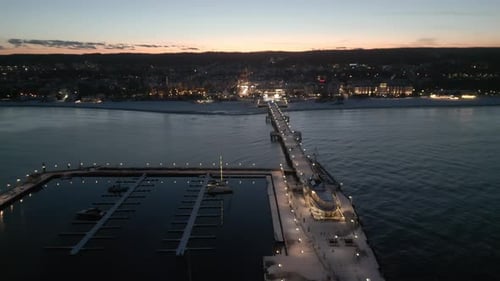 Evening illumination of Sopot pier, Poland at winter sunset, aerial view