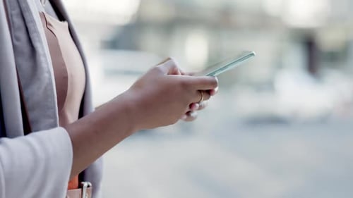 Texting, phone and hands of woman in city for networking, social media app and connection