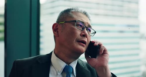 Man, stress and phone call in office of Japan, networking and news of tax mistake by window