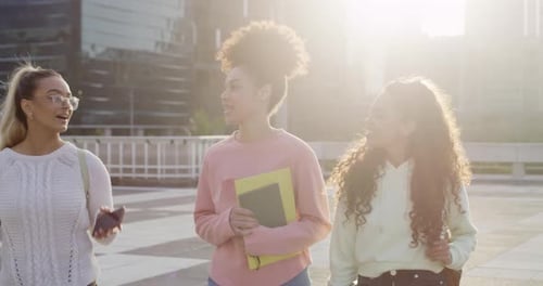 Walking, university students and women laughing in city at joke, comedy or humor