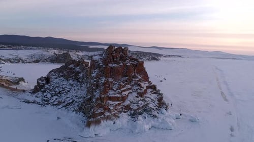 Aerial Orbital Shot of a Shamanka Rock on Olkhon Island at Sunset Winter Landscape Popular Touristic