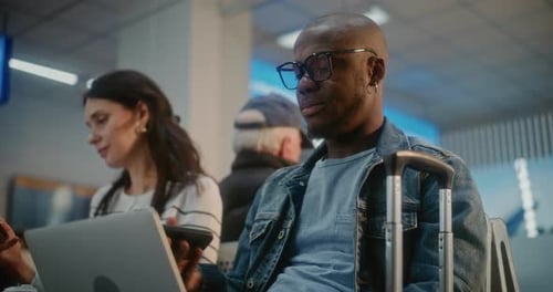 Airport Terminal Entrepreneur Doing Remote Work on Laptop Using Phone