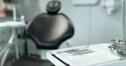 Healthcare, dentist and chair with tools in office, oral hygiene or wellness with ergonomics