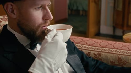 Aristocrat Sipping Tea from China Cup While Reading Newspaper