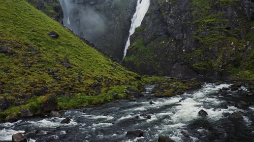 Voringfossen Waterfall and Sorrounding Valley in Rainy and Fogy Typical Norway Weather Captured By