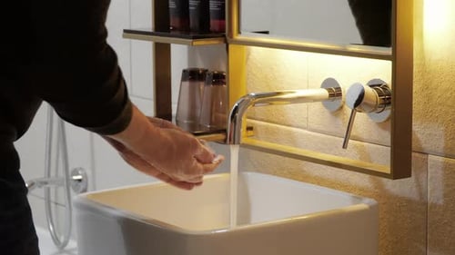 Man washing hands with soap in bathroom - hands close-up. coronavirus prevention hand hygiene