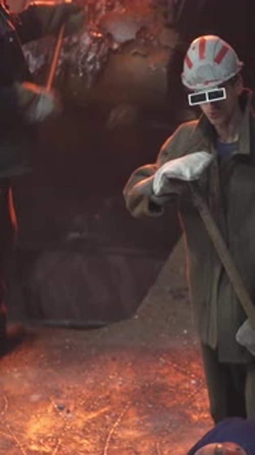 Workers Who are Engaged in Handling Molten Material in an Industrial Foundry Setting Stock Clip