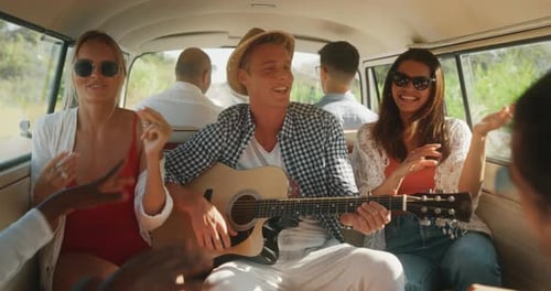 Footage Inside a Van: Slow Motion of Stylish Joyful Men and Women Having Fun While Playing Guitar i