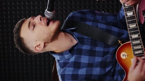 Young man with guitar playing songs