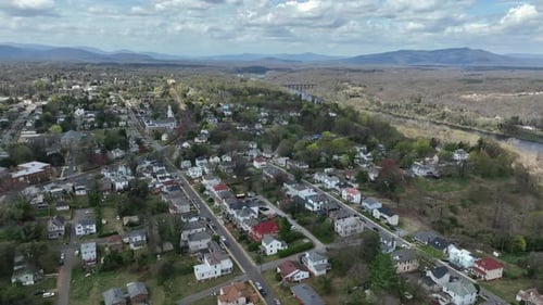 Colonial and victorian houses and homes in small American village during spring season. Descend dron