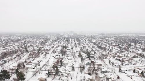 Aerial, suburb neighborhood in the United States covered in snow during winter