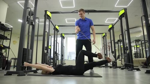 Therapist Stretching Female Athlete in Clinic Sports Physical Therapy Concept Rehabilitation of