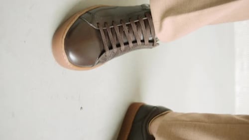 Close up of person wearing brown shoes