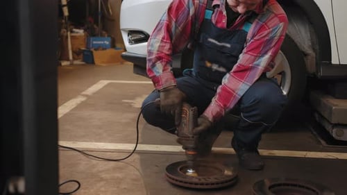 Cleaning Disc Brake on Car in Process of New Tire Replacement Car Brake