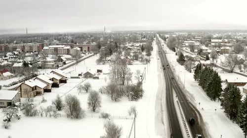Establishing shoot of highway going into small city. Rule of third. Afternoon traffic.