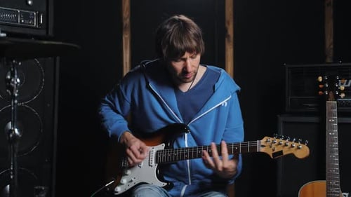 Footage of Musician Playing on Electric Guitar at Sound Recording Studio