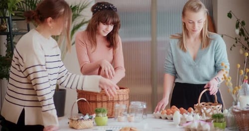 Mother and Daughter are Painting Easter Eggs for Easter Holidays