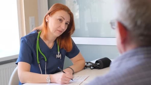 A Cardiologist Talks to a Patient in His Office Heart Problems in an Elderly Man Modern Clinic