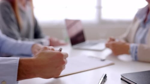 Close Up View of Young Couple Signing Contract After Buying First Property