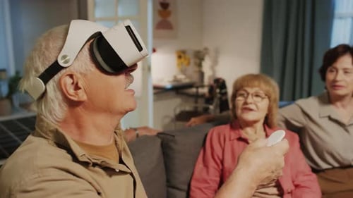 Senior Man Switching Modes on VR Glasses when Sitting Together with Friends