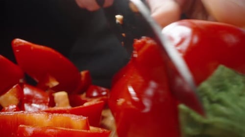 I cut the red sweet pepper lengthwise. Dolly slider extreme close-up.