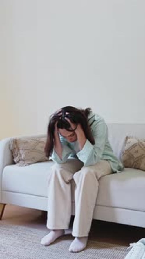 Woman Suffering From Depression and Anxiety on Sofa