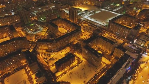 City with Lit Streets and Buildings Glowing at Night