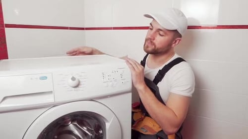 professional plumber connects the washing machine
