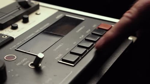 Pressing Stop and Rewind Buttons on Vintage Reel to Reel Audio Tape Recorder, Close Up