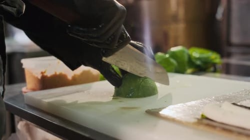 Closeup Chef Cutting Avocado Making Sushi in Kitchen