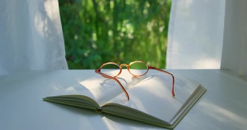 Sunlight slowly wanders onto an open book