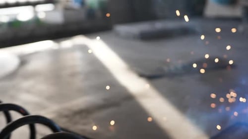 Welder on the table welds a set of metal parts. Welder working. Working with metal