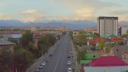 View from rising drone on road city Bishkek, capital of Kyrgyzstan in Central Asia.