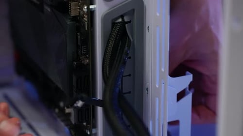 Closeup Hands of Unrecognizable Man Doing Electrical Wiring Inside System Unit of Modern Gaming