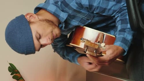 Musician playing chords on acoustic guitar