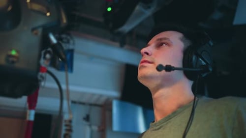 Cameraman Wearing Headset Operating Broadcast Camera During Studio Filming