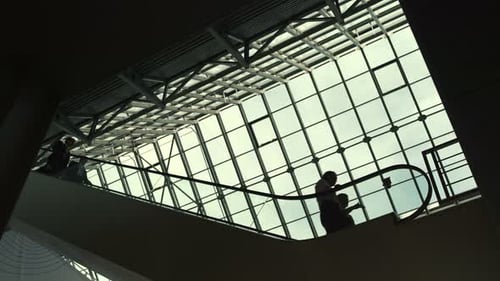 Movement of People on Moving Stairway Inside Structure of Financial Company Or