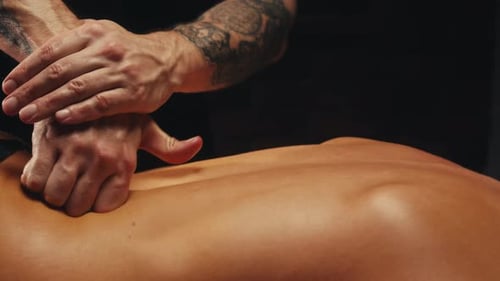 Man Masseur Hands Giving Massage to Female Body Closeup Relax and Restorative Massage Procedure at