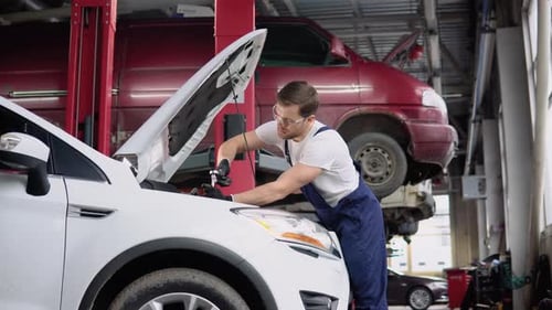 Automobile Mechanic Repairman Hands Repairing a Car Engine Automotive Workshop with a Spanner