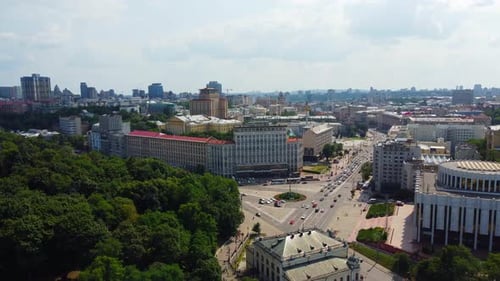 Traffic at European Square in Kyiv Downtown. Aerial drone shot above Ukrainian city streets on a sun