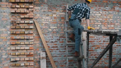 Construction worker in uniform and safety equipment have job on building